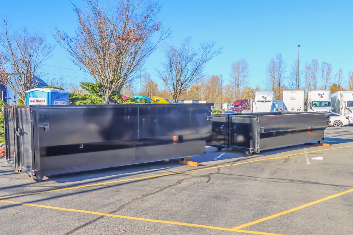 Professional dumpster rental service with roll-off container on residential driveway in Winthrop Town